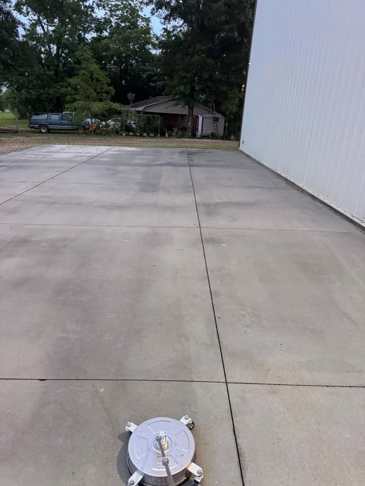 Surface cleaner being used on a concrete driveway by Pickup Pressure Washing