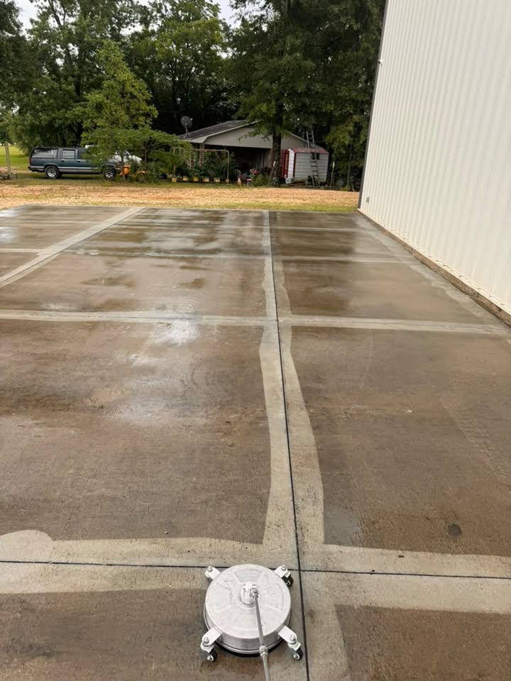Pickup Pressure Washing cleaning a large concrete surface in Southern Mississippi